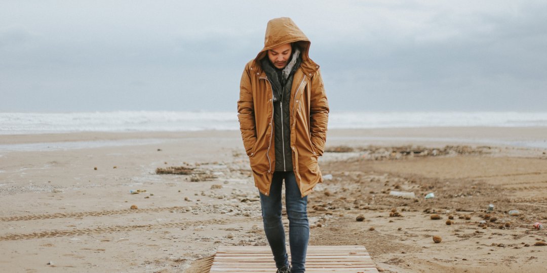 Man walking by the beach in the winter