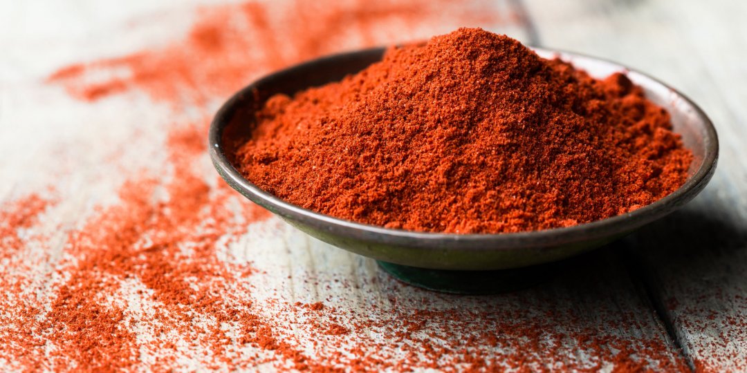 Paprika in a bowl on a wooden table