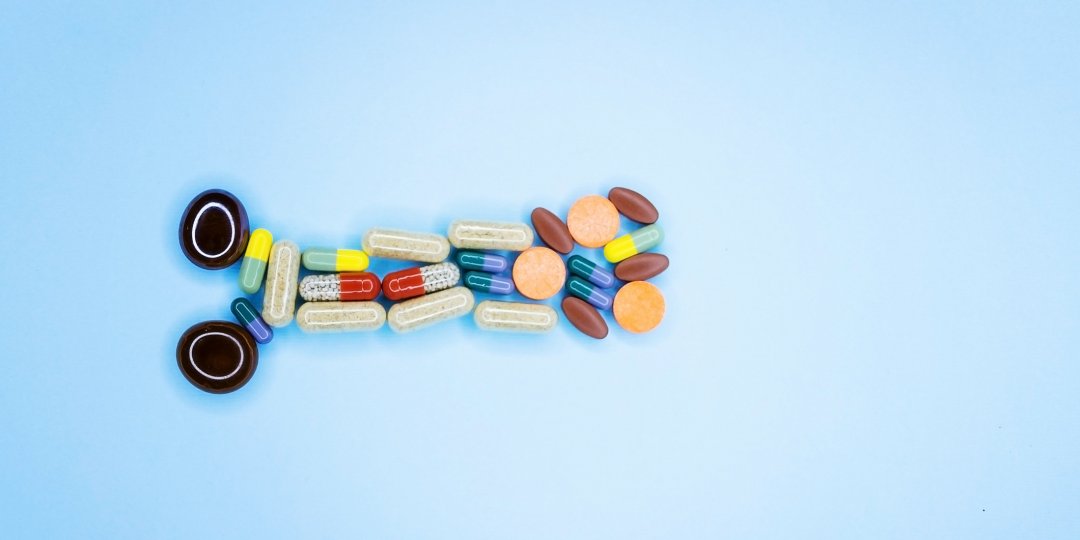 Pills arranged on a blue background